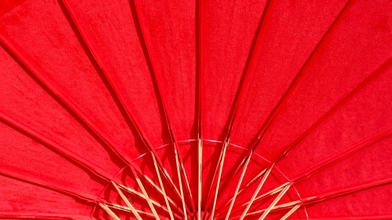Red umbrella with wooden spokes to the centre