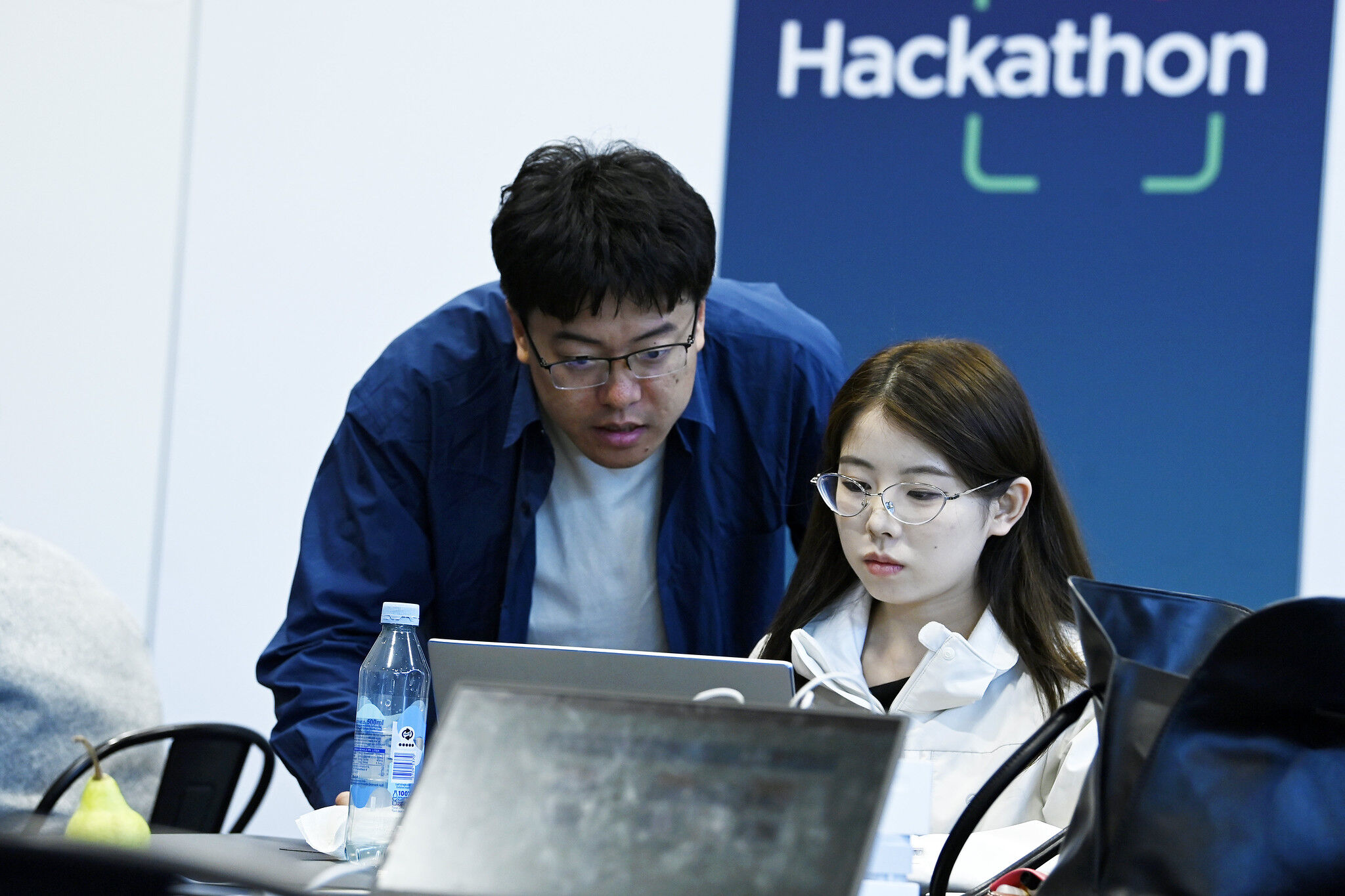 Two people at a Hackathon at DTW Ignite 