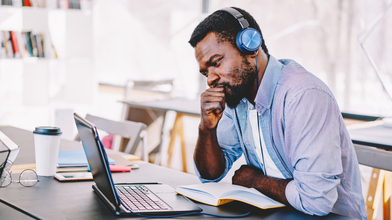 Man at laptop with headphones