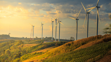Wind turbines on a hill, orange light